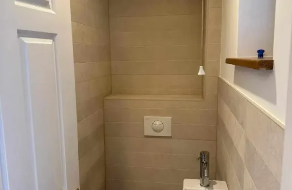 Toilet and hand basin in narrow cloakroom