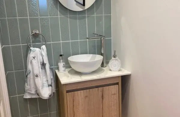 Small cloakroom with vanity unit.