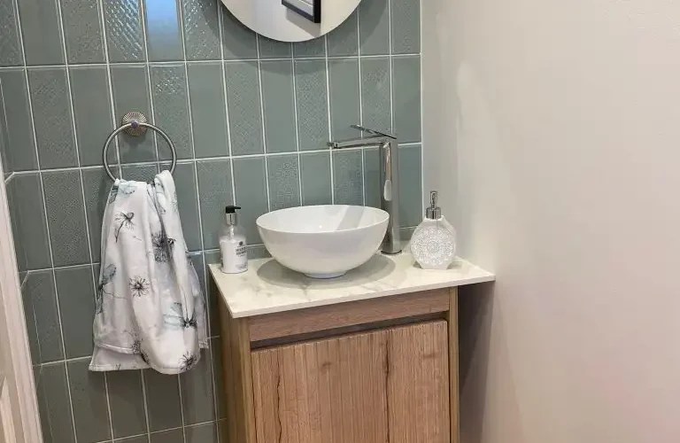 Small cloakroom with vanity unit.
