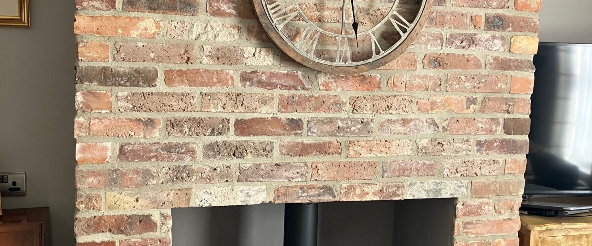 Frontage of brick and slate built garage built in the grounds of at listed building