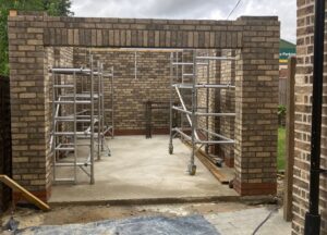 Triangular area between existing driveway and garage requiring seamless block paving 