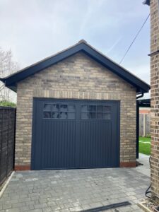 Motorised up and over garage door in county style to match character of house